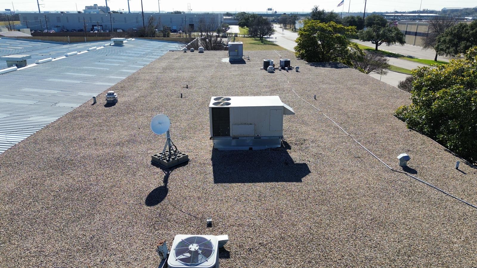 Gravel-surfaced commercial roof and rooftop equipment